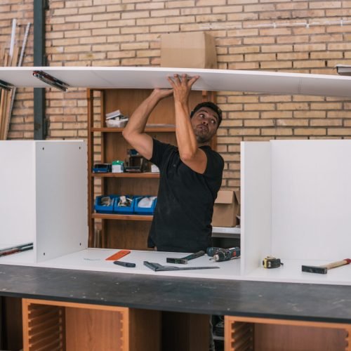 man-assembling-furniture-for-a-kitchen-in-a-worksh-2024-10-18-04-56-43-utc-2048x1365